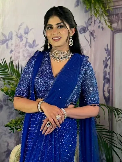 A bold statement of elegance. This bride chose a regal royal blue for her engagement half saree, and the result is breathtaking. The entire piece is embellished with shimmering beadwork that catches the light beautifully.