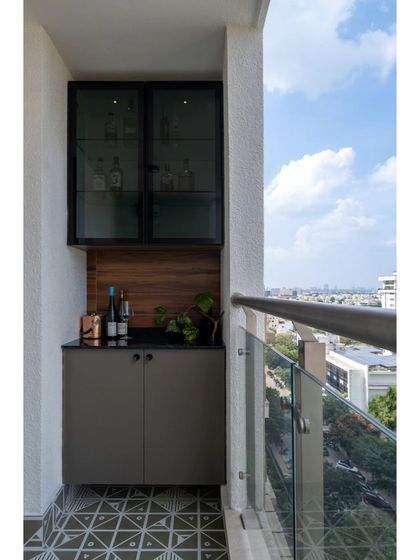 The balcony of the bachelorette pad, featuring stylish geometric tiles and a compact bar unit. This space provides a relaxing spot to unwind while enjoying views of the city.