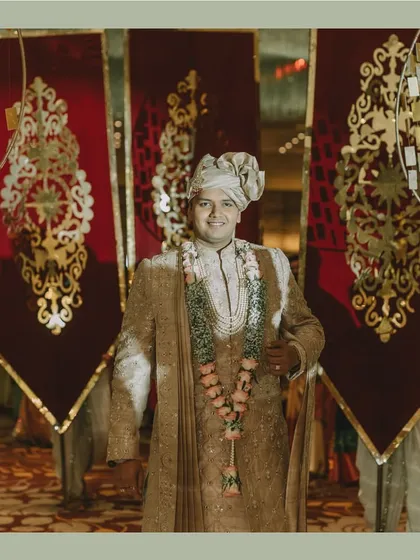 The groom's royal entry, looking majestic against a backdrop of ornate banners. We design every entry to be a statement.