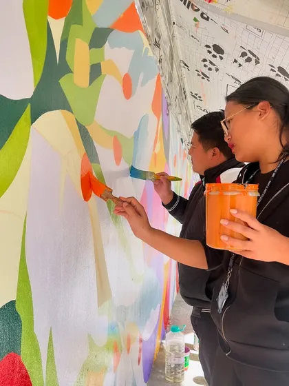 Working alongside students at St. Claret College in Ziro. Their energy and support were a huge part of making the 100-foot mural project a success.