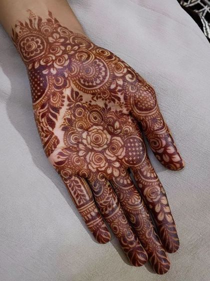 A perfect example of a mature henna stain. The intricate floral and paisley patterns are sharp and clear, and the color is a beautiful deep reddish-brown.
