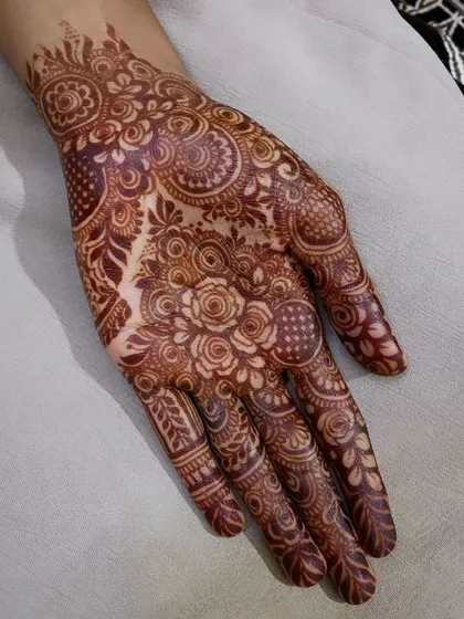 A perfect example of a mature henna stain. The intricate floral and paisley patterns are sharp and clear, and the color is a beautiful deep reddish-brown.