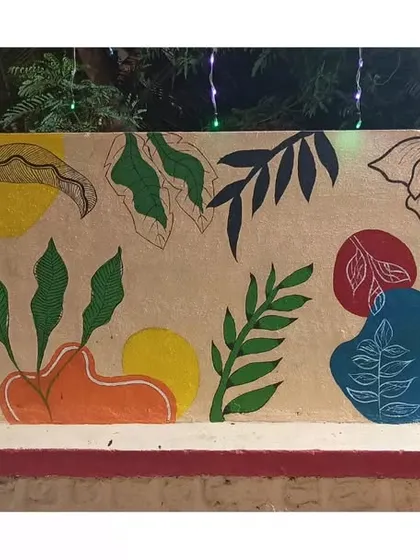 This long wall features an abstract design combining organic leaf shapes with bold, colourful blocks. It's a modern take on a botanical theme.