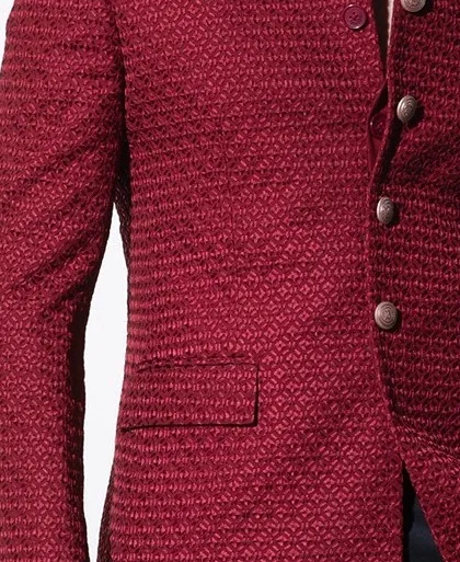 Another close-up of the crimson bandhgala's unique fabric. This view highlights the meticulous weave and rich color that define this standout piece of formalwear.