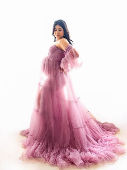 A soft and dreamy pose with a sheer, flowing gown. The way the light shines through the fabric creates an ethereal and artistic look.