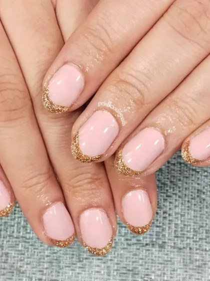 A soft and pretty look with rose gold glitter French tips on a baby pink base. This is a lovely choice for weddings or any elegant occasion.
