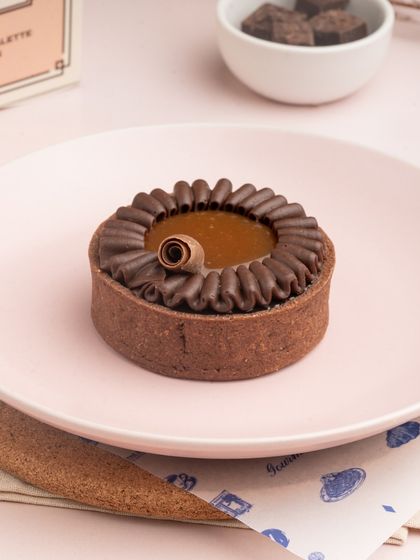 The rich, dark filling of my Sea Salt Caramel Tart, surrounded by a piped border of chocolate cream.