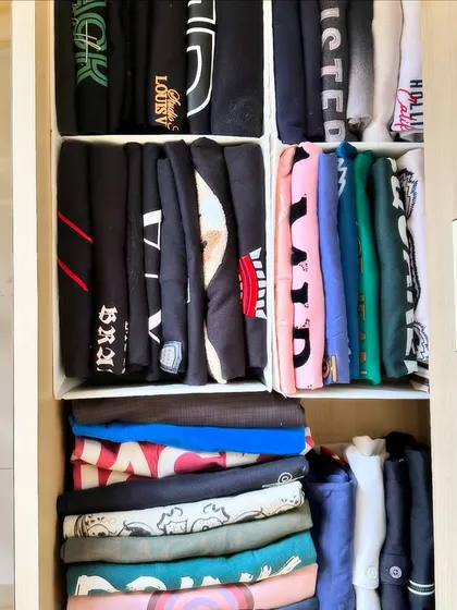 Another example of file-folding in action. These t-shirts are organized in bins, making it easy to see graphics and pull one out without messing up the rest.