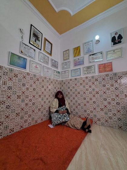 Me, sitting in my studio, surrounded by my certificates. Each one is a reminder of my journey and a source of inspiration for my students.