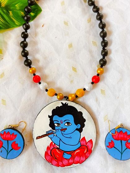 A playful depiction of Baal Gopal (young Krishna) with his flute, sitting on a lotus. This hand-painted set is full of charm and innocence, perfect for those who appreciate mythological art.