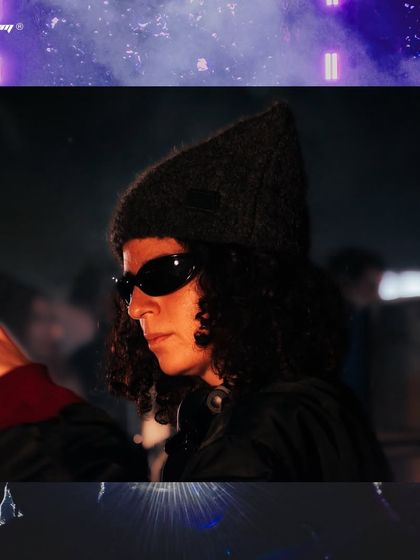 A creative, framed shot of DJ Carlita at Zamna India, giving the photo a unique, stylized look.