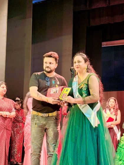 The owner himself presenting the award to our client in the green ball gown. It's always a joy to see my outfits be a part of your success.