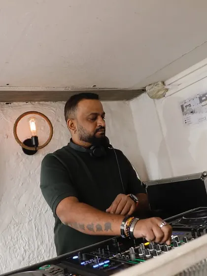 Another angle from a night at Olive. I'm deep in the mix, focused on blending tracks. The setup is professional, and the vibe is always on point.