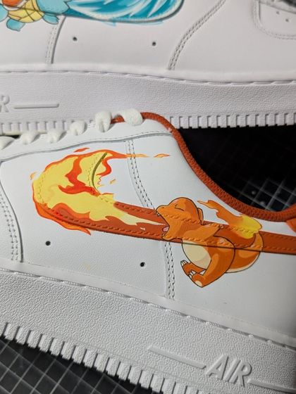 The Charmander side of the Pokémon Air Force 1s, where his flamethrower attack creates the fiery swoosh. A perfect fire and water duo.