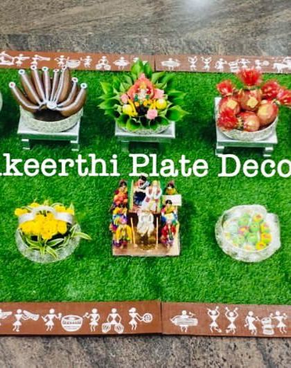 This ear-piercing ceremony setup in Erode features a unique Warli art border on the carpet. The props, like the miniature swing and walker, add a playful touch.