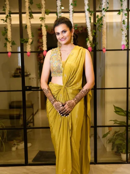 A full-length shot of the modern draped saree for a Mehendi event. The look is chic, comfortable, and effortlessly stylish.