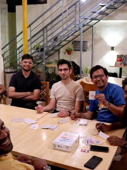 A lively game of 'Just One' brings this group together for an evening of laughter and fun. It's a perfect icebreaker for making new friends.