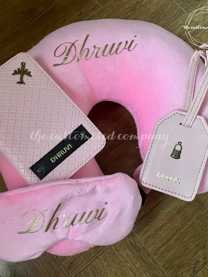 A perfectly coordinated travel set for her, in a lovely shade of pink. This matching collection comes with a personalized neck pillow, eye mask, passport cover, and luggage tag, ensuring she travels in style.