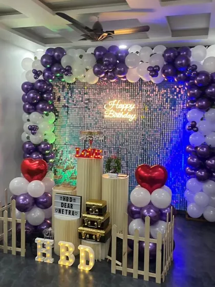 A full view of the purple and white balloon arch against the sequin wall. This theme is great for anyone looking for a vibrant and stylish birthday party venue.