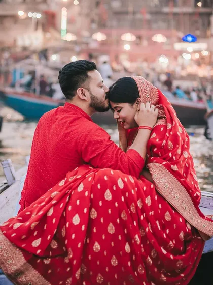This pre-wedding shoot on the ghats of Varanasi was about finding a quiet moment of connection amidst the city's eternal rhythm. The groom's gentle kiss and the bride's serene smile tell a story of love against a backdrop of timeless tradition.