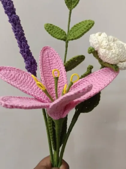 A delicate bouquet of handmade crochet flowers, featuring a pink lily and lavender. Unlike real flowers, these are allergy-friendly and require no maintenance.