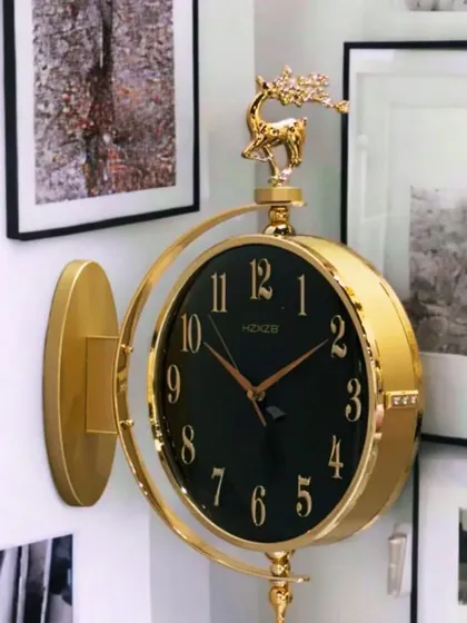 This elegant double-sided station clock features a bold black face with gold numerals for a striking contrast. The antique gold finish and decorative deer motif add a touch of classic luxury, making it a standout piece in any setting.