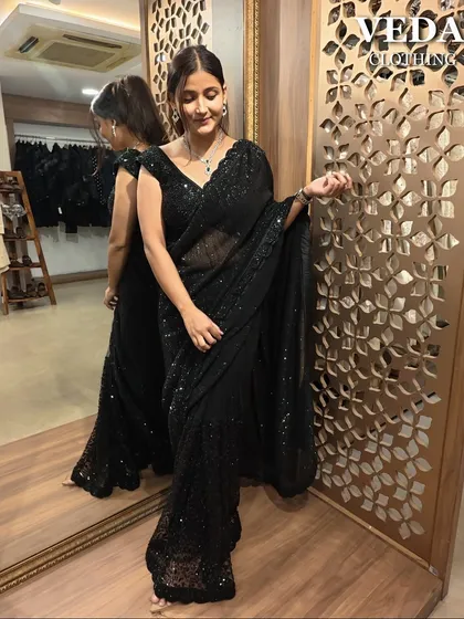 This saree is all about effortless glamour. The light fabric is covered in sequins that catch the light perfectly.