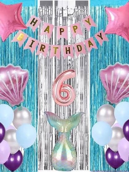 A simple mermaid theme for a 6th birthday. This kit-style decoration includes a blue fringe curtain and various mermaid-themed foil balloons.