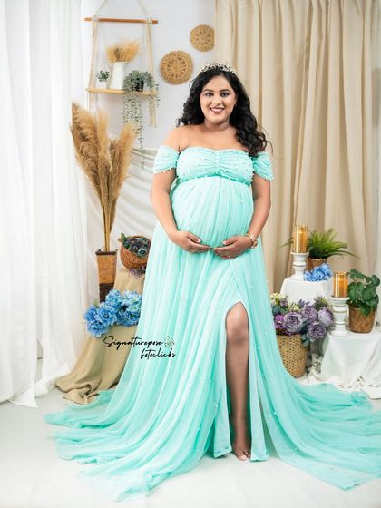 A stunning full-length portrait in a flowing mint-colored gown, with a crown for a touch of royalty.