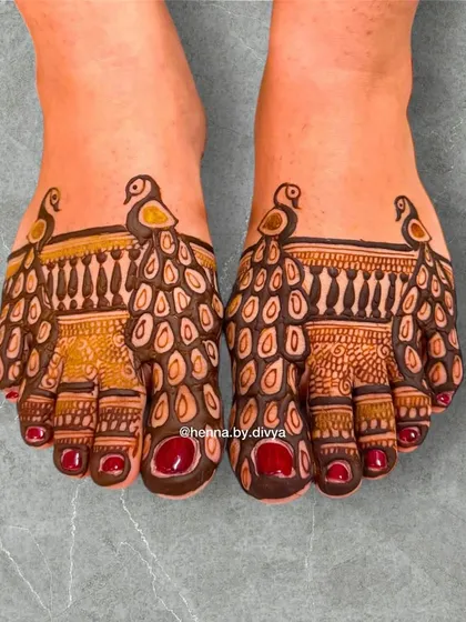A bold and unique peacock design for the feet. The pattern covers the toes and front of the foot, creating the illusion of a peacock with its feathers on display.