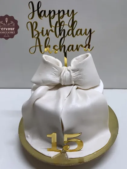 A simple and elegant half-kilogram chocolate truffle cake with a white fondant bow. Perfect for a smaller, more intimate celebration.