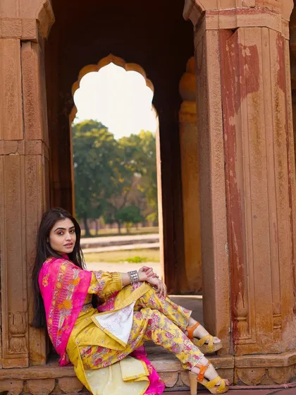 A full-length seated portrait that feels both regal and relaxed. This pose is great for showing off the entire outfit, including the stylish footwear.