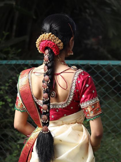 A detailed view of the traditional bridal hairstyle, featuring an intricate braid and floral accessories, which is a key part of the South Indian bridal look.