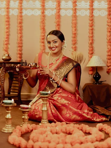 A happy portrait, with the model holding a thali of diyas. The smile and the warm light perfectly capture the essence of the festival of lights.
