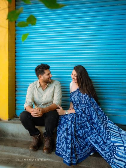 Capturing the simple joy of sharing a moment together. This urban photoshoot uses a bold, colorful backdrop to highlight the couple's connection.
