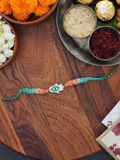 A flat-lay of the Hamsa Rakhi, ready for the festival.