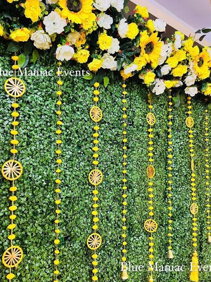 Another detail shot of the grand Haldi setup, this time focusing on the hanging decorations with wheel-like motifs.