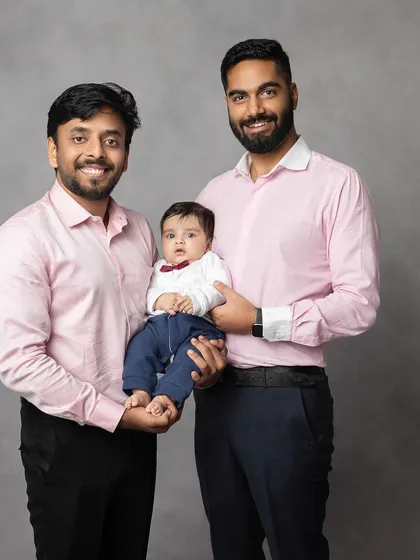 A classic portrait of the father and his brothers with the baby. These multi-generational photos become incredibly precious heirlooms over time.