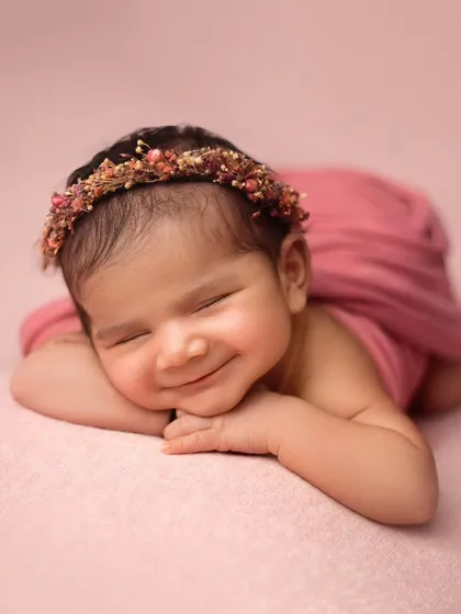 This is the kind of sleepy, peaceful smile that I live to capture. This little girl was an absolute dream, and her portrait shows the soft, artistic style I bring to every newborn session.