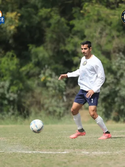 A moment of control. A player calmly brings the ball down, ready to launch the next attack. Poise under pressure is key to our game.