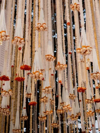 A close-up of the intricate hanging floral tassels. These details add texture and movement to the overhead decor, creating a truly immersive experience.
