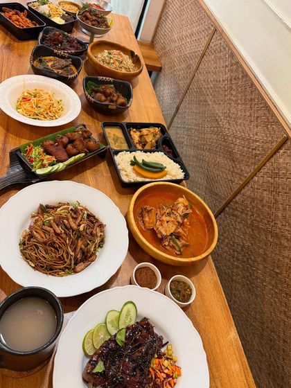 A long view of the table, laden with a variety of our signature dishes. This is what a true Naga celebration looks like, full of flavor, variety, and community.