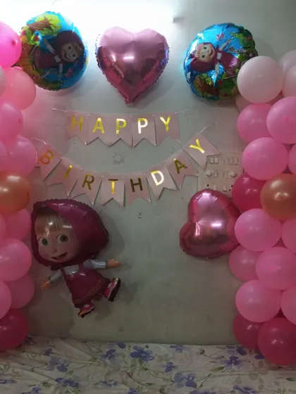 The combination of pink balloons and themed foils creates a perfect party atmosphere.