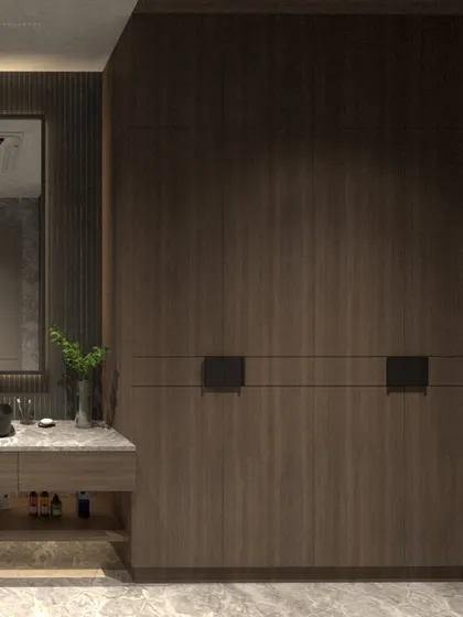 Another view of the villa bathroom, focusing on the custom wardrobe with integrated handles and its relationship to the vanity area. The design is all about clean lines and rich textures.