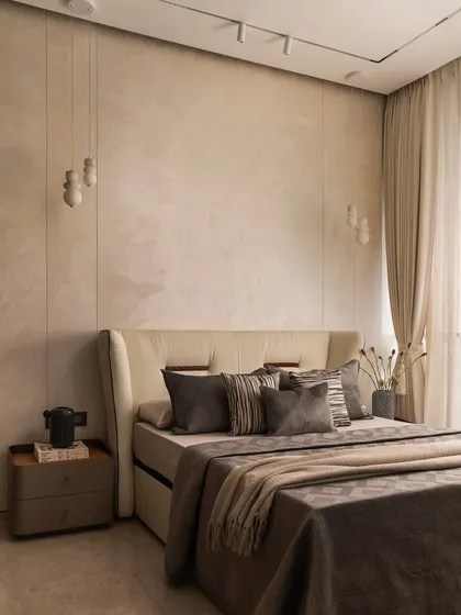 I believe a neutral palette is the perfect canvas for tranquility. In this master bedroom, I layered various shades of beige and grey with different textures, from the plush headboard to the soft linens, creating a space that feels both sophisticated and incredibly restful.