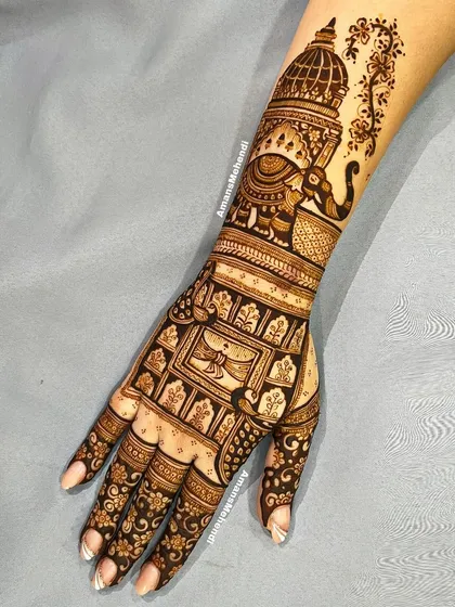 This detailed back-hand design features a royal elephant under a canopy on the wrist, with a grid of traditional motifs covering the hand.