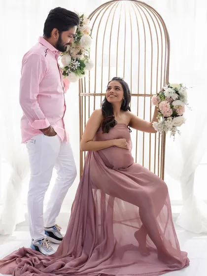 A sweet and romantic couple's maternity shot. The soft, natural makeup ensures the focus remains on the beautiful connection and the joy of the moment.