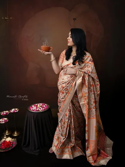 A moment of tranquility. This traditional portrait shows the mom-to-be in a beautiful saree, holding a steaming cup, creating a serene and culturally rich image.