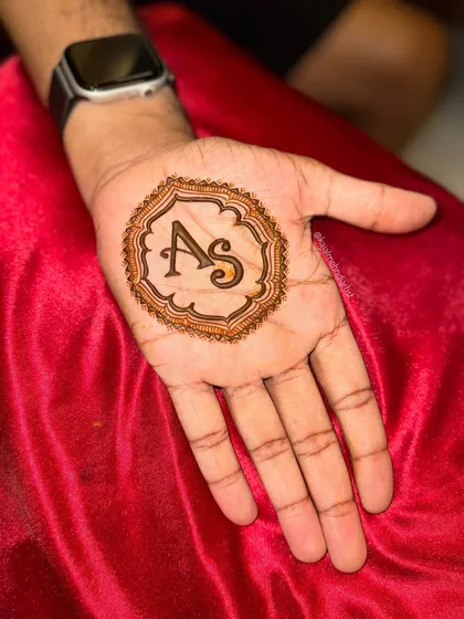 A clean, crisp shot of the 'AS' initial design for the groom, showing the bold lines and shading.