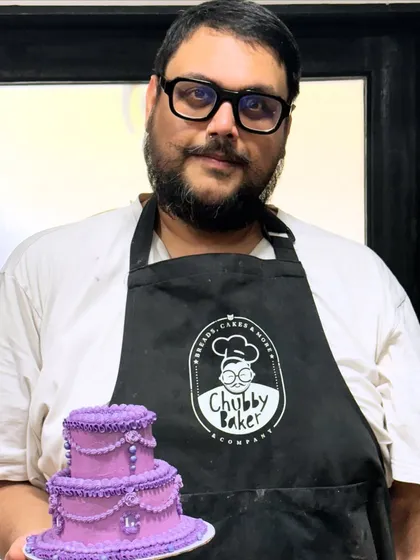 Here I am with a mini version of a tiered vintage cake I made for a client's celebration. I love connecting with my customers and being a small part of their big moments. This is what it's all about: making an impact, one delicious and beautiful cake at a time.